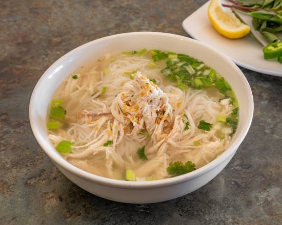 Chicken noodle soup with rice noodles and herbs